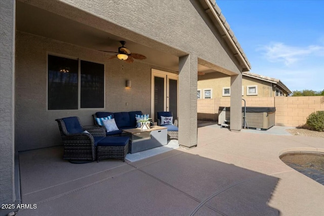 view of patio featuring ceiling fan, a hot tub, and an outdoor hangout area