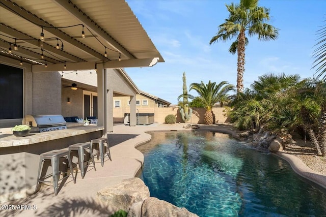 view of swimming pool with a patio area, area for grilling, and exterior bar