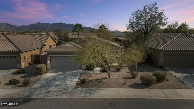 view of front of home with a mountain view and a garage