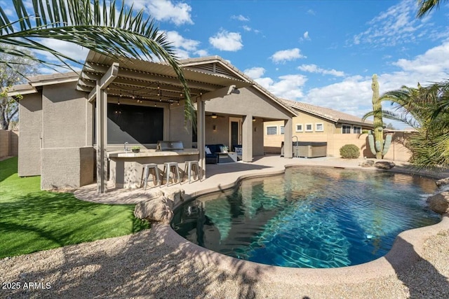 view of swimming pool featuring ceiling fan, exterior bar, and a patio