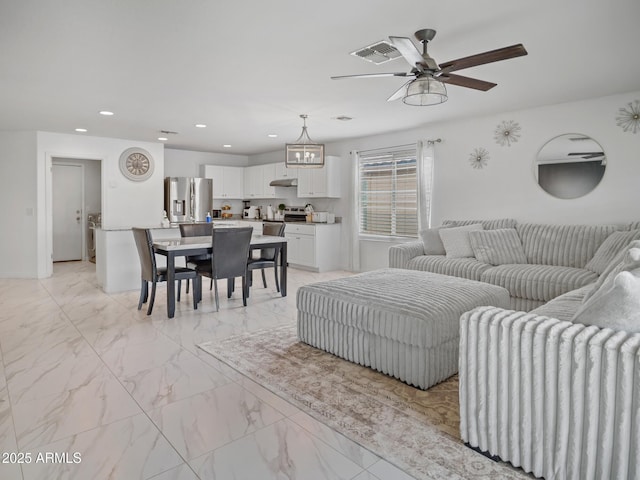 living room with recessed lighting, visible vents, marble finish floor, and ceiling fan