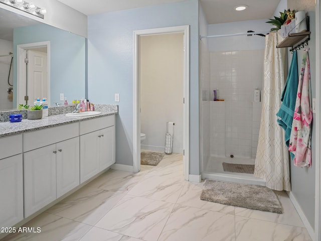 bathroom featuring vanity, baseboards, a shower stall, toilet, and marble finish floor