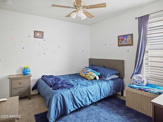 bedroom with ceiling fan and carpet flooring