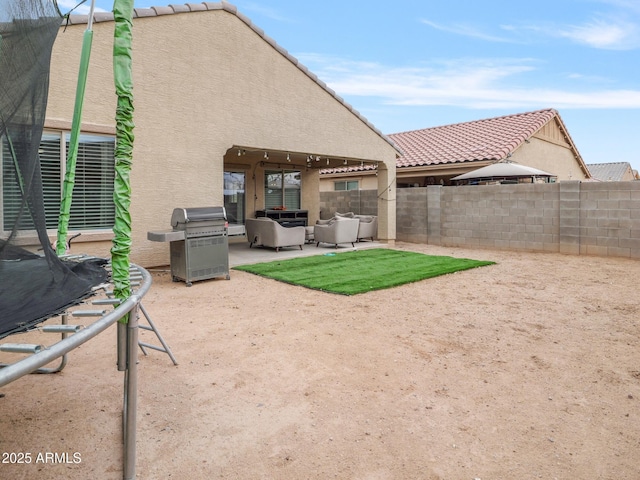 exterior space with a grill, an outdoor hangout area, and fence