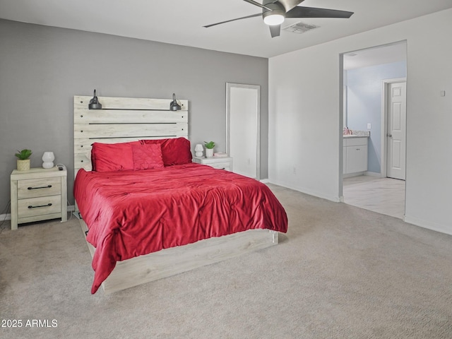 bedroom with visible vents, baseboards, ceiling fan, carpet flooring, and ensuite bath