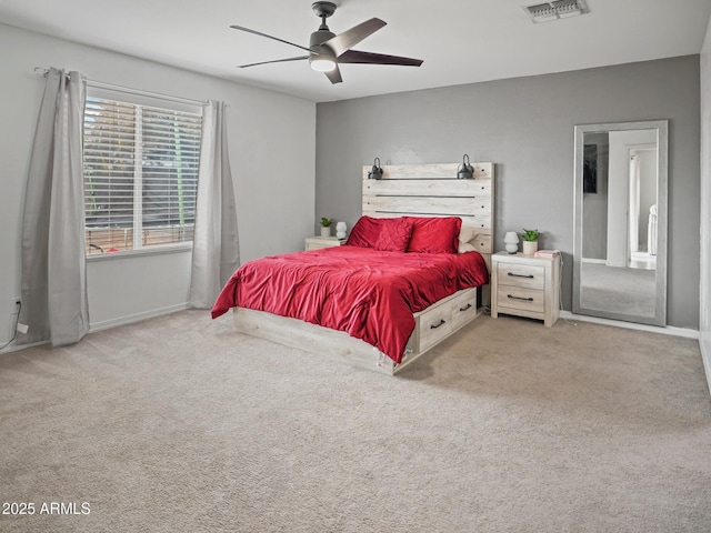 carpeted bedroom featuring a ceiling fan, visible vents, and baseboards