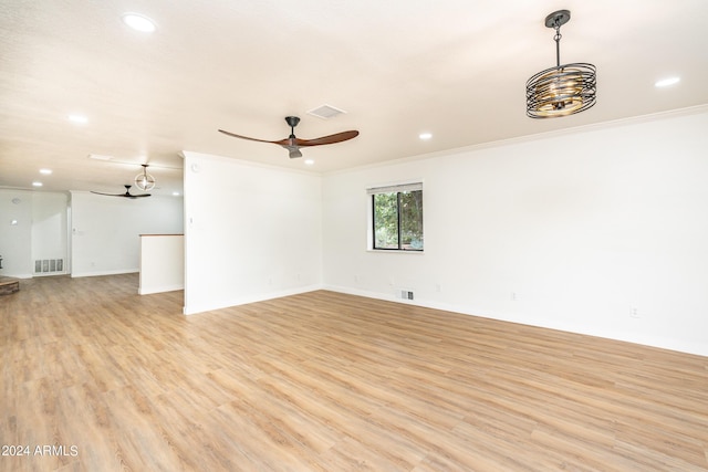 empty room with light wood-type flooring, ceiling fan, and crown molding