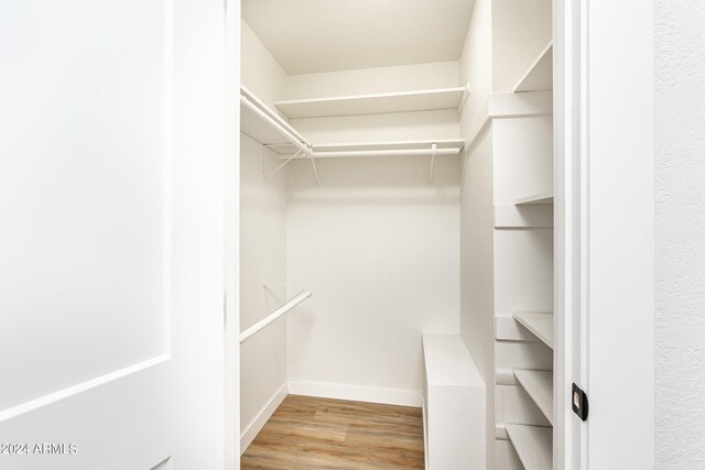 walk in closet featuring light hardwood / wood-style flooring