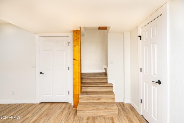 staircase with hardwood / wood-style flooring