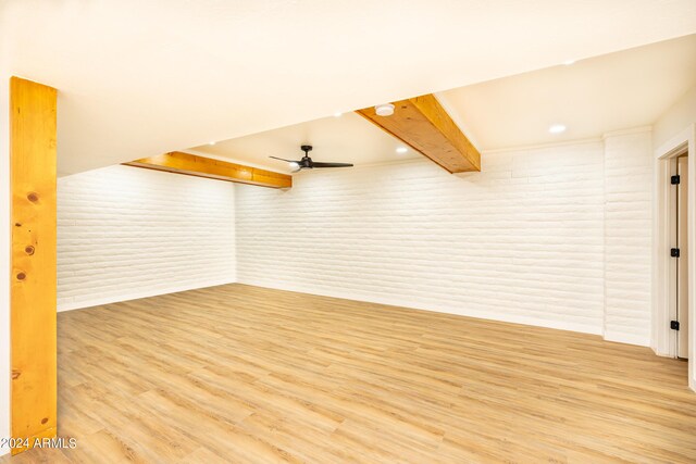 spare room featuring brick wall, ceiling fan, and light hardwood / wood-style floors