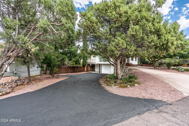 obstructed view of property with a garage