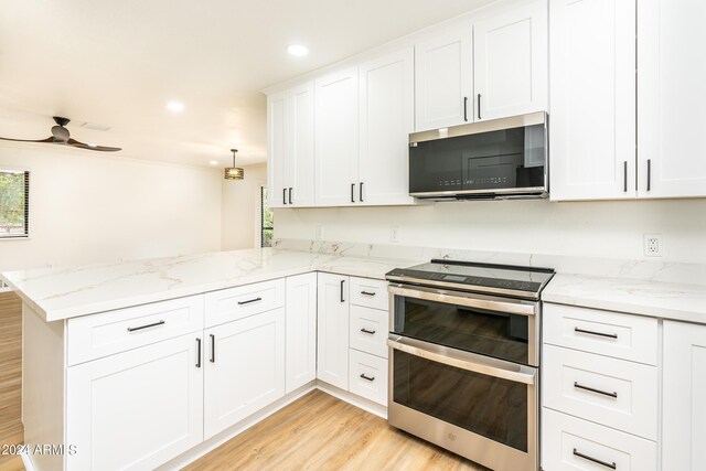 kitchen with light wood-type flooring, stainless steel appliances, white cabinetry, kitchen peninsula, and ceiling fan