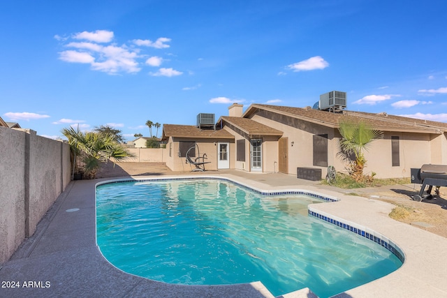 view of swimming pool featuring a patio area and central AC