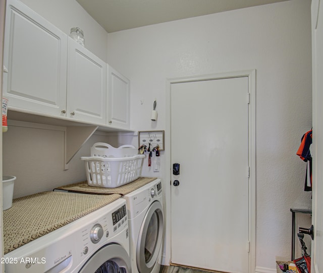 washroom featuring cabinets and separate washer and dryer