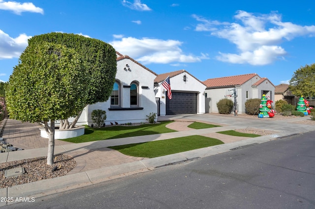 mediterranean / spanish home with a garage