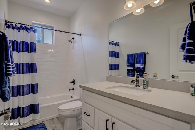 full bathroom featuring shower / bath combo, vanity, hardwood / wood-style flooring, and toilet