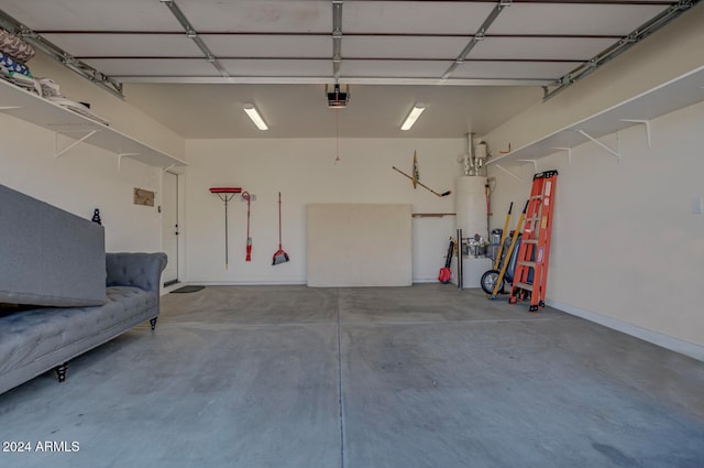 garage with a garage door opener and gas water heater