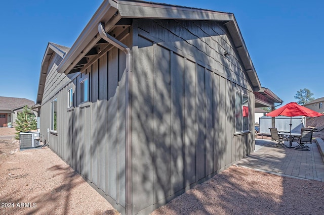 view of side of property featuring central AC unit and a patio