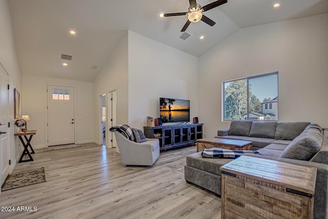 living room featuring ceiling fan, light hardwood / wood-style flooring, and high vaulted ceiling