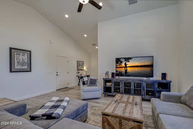 living room featuring ceiling fan, light hardwood / wood-style flooring, and high vaulted ceiling