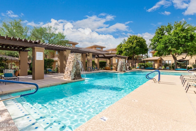 community pool with a patio area, fence, and a pergola