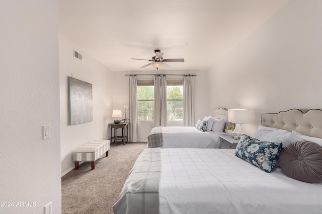 bedroom featuring light carpet, visible vents, and a ceiling fan