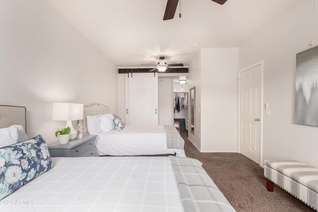 bedroom with carpet floors, a spacious closet, and a ceiling fan