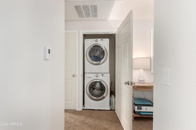 washroom featuring visible vents, carpet floors, laundry area, and stacked washer / drying machine