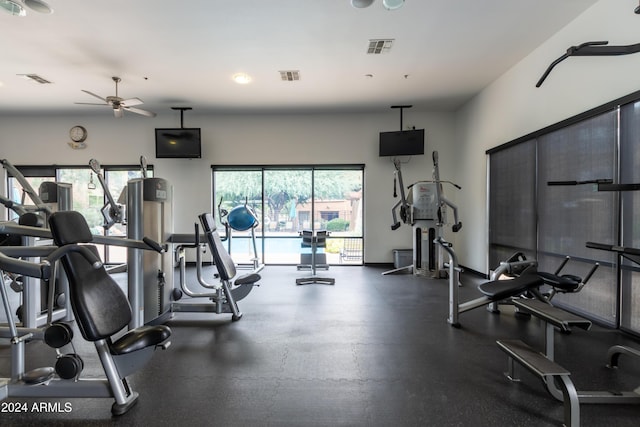 exercise room with a ceiling fan, visible vents, and baseboards