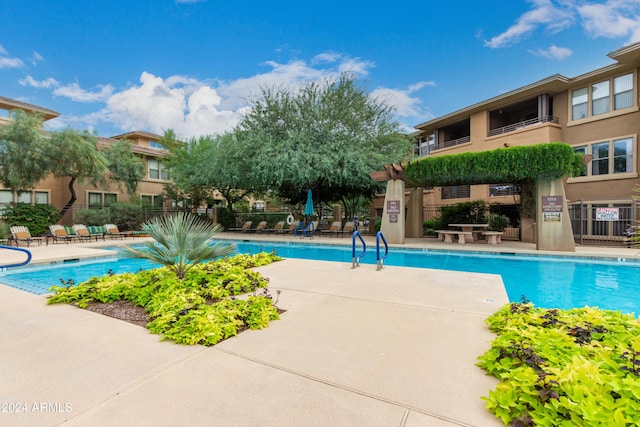 community pool featuring a patio area and fence