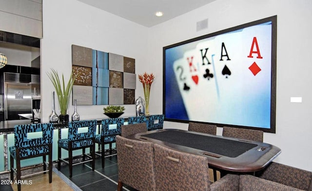 dining area featuring dark tile patterned flooring and visible vents