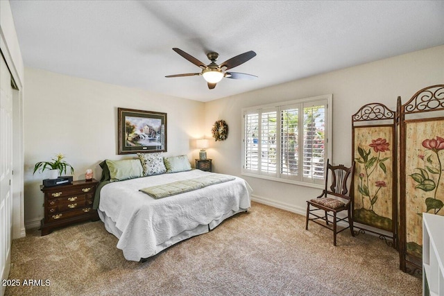 carpeted bedroom with a closet, a ceiling fan, and baseboards