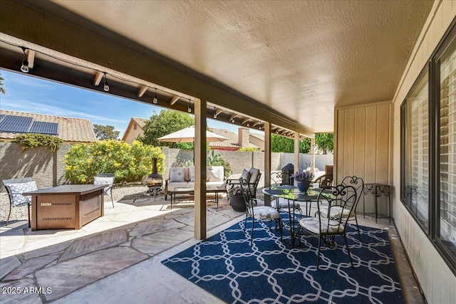 view of patio / terrace featuring a fenced backyard, outdoor dining area, and an outdoor living space