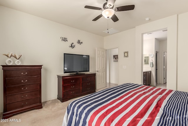 bedroom featuring light carpet, ensuite bath, and ceiling fan