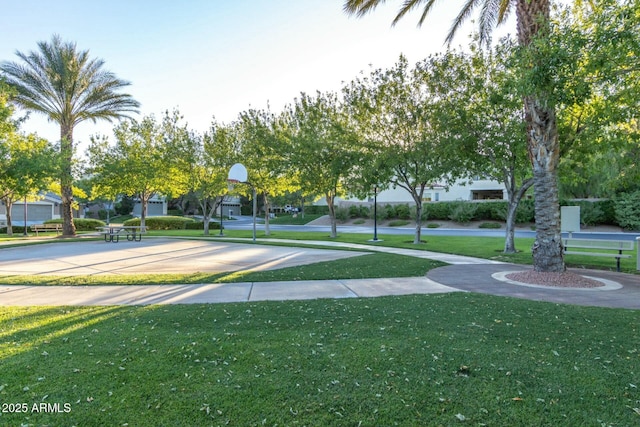 view of community featuring a yard and basketball court