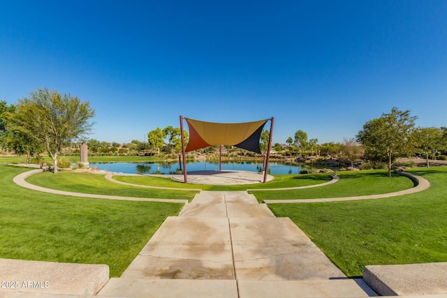 view of property's community featuring a yard and a water view