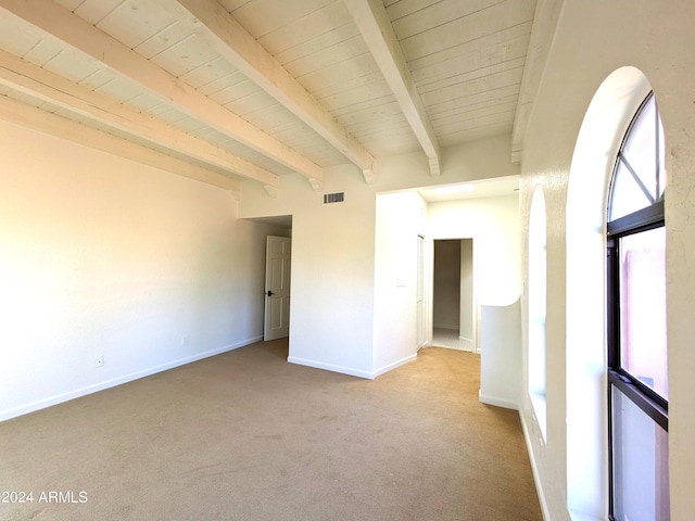 carpeted spare room featuring wood ceiling, baseboards, visible vents, and beamed ceiling