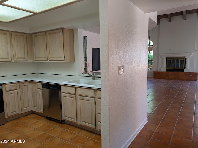 kitchen featuring a sink, light brown cabinets, light countertops, and stainless steel dishwasher