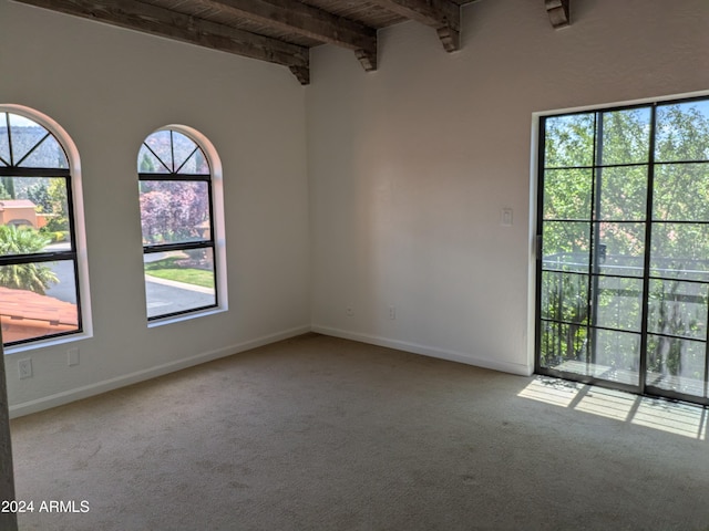 carpeted empty room with beamed ceiling, wood ceiling, and baseboards