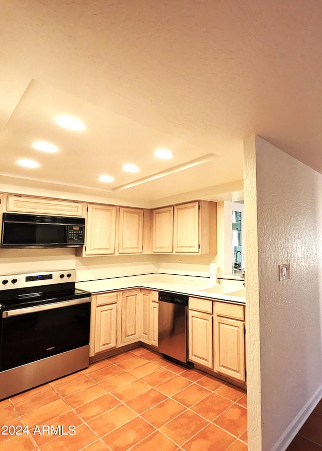 kitchen with stainless steel appliances, recessed lighting, light countertops, light brown cabinets, and light tile patterned flooring