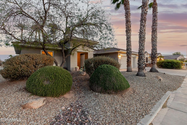 view of front of property featuring stucco siding, a garage, and concrete driveway