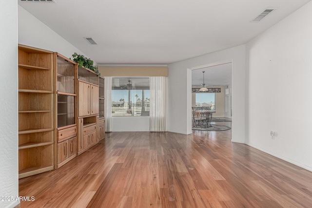 unfurnished living room with light wood-style flooring and visible vents