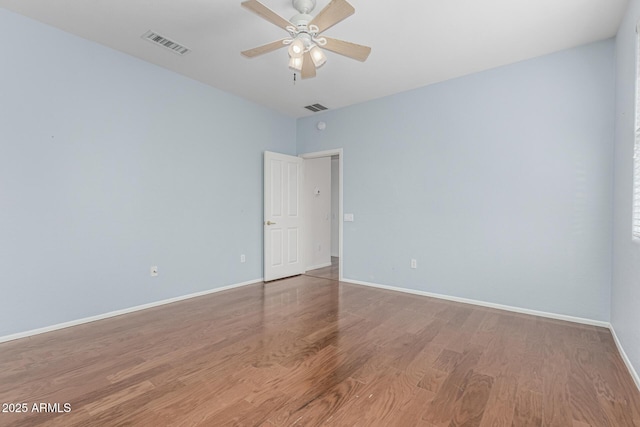 unfurnished room with light wood-style floors, visible vents, ceiling fan, and baseboards