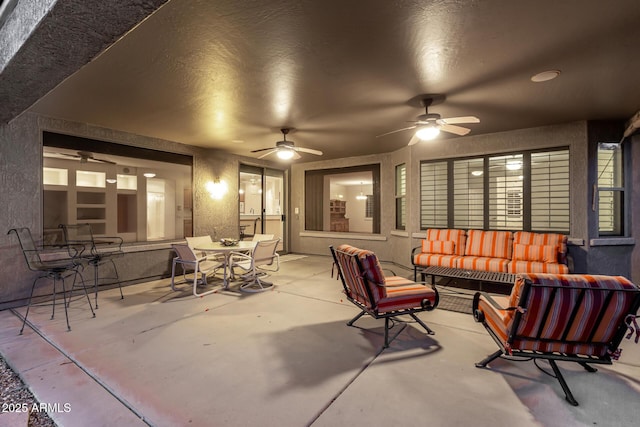 view of patio / terrace featuring a ceiling fan, outdoor dining space, and an outdoor living space