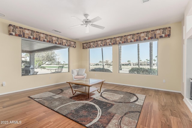 sitting room featuring baseboards, visible vents, ceiling fan, and wood finished floors