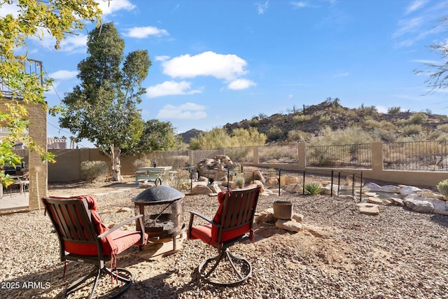 view of patio featuring a mountain view and a fire pit