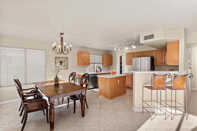 tiled dining space with a chandelier