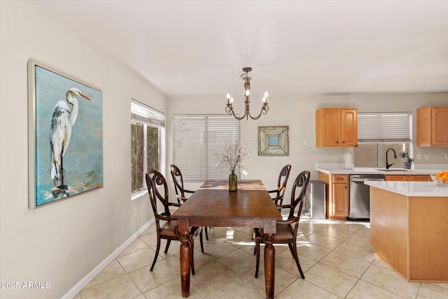 tiled dining area with sink and a chandelier