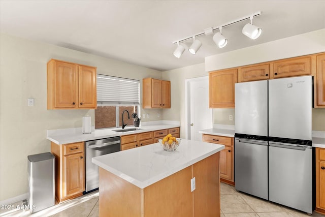 kitchen with light stone counters, a center island, light tile patterned floors, appliances with stainless steel finishes, and sink