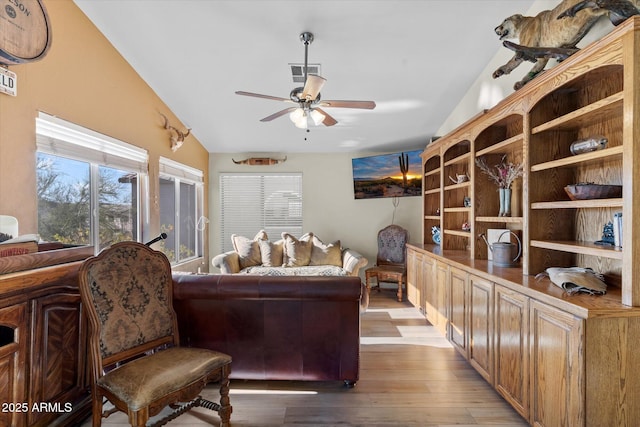 interior space featuring ceiling fan, vaulted ceiling, and light hardwood / wood-style flooring